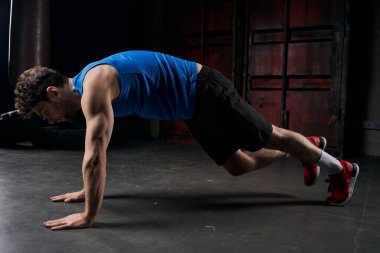 full length of resilient man in sportswear training in plank pose in night city, street workout clipart