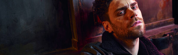 portrait of frustrated man with injured unshaven face in dark post-apocalyptic subway, banner