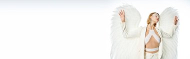 divine beauty, woman in costume of light winged angel standing with closed eyes on white, banner clipart