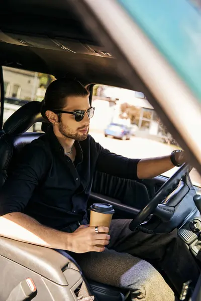 stock image tempting driver with earring and wristwatch holding coffee cup while sitting behind steering wheel