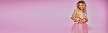 beautiful woman in pink outfit holding magic wand on pink background, tooth fairy concept, banner clipart