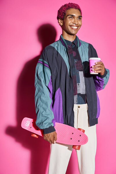 good looking man acting unnaturally like male doll smiling weirdly with coffee and skateboard