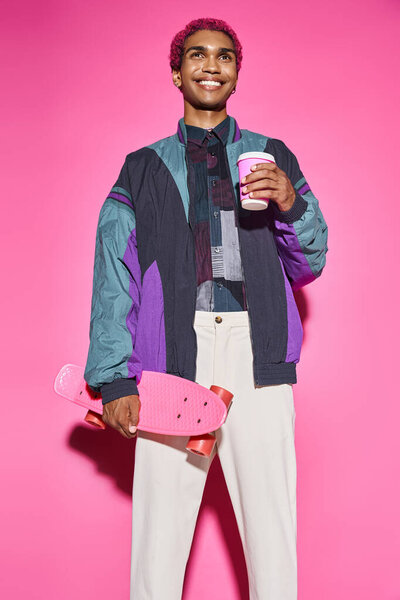 stylish african american man standing still smiling weirdly with coffee and skateboard, doll like
