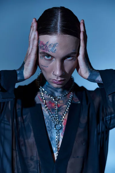 stock image vertical shot of handsome young man in transparent shirt with hands on his head, fashion concept