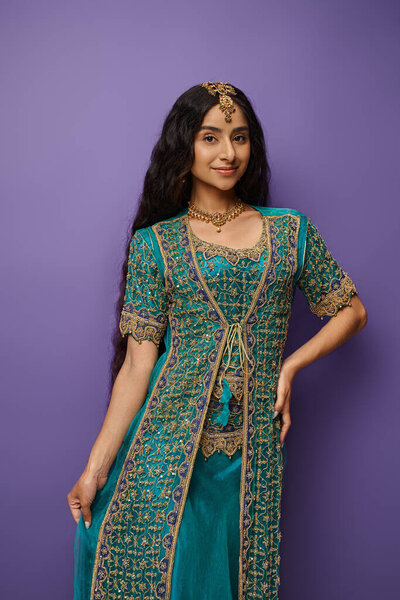 vertical shot of attractive young indian woman in national costume smiling cheerfully at camera