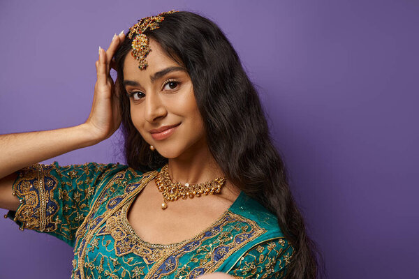 beautiful smiley indian woman in traditional blue sari smiling joyfully and looking at camera