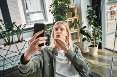 vertical shot of red haired androgynous model in black stylish turtleneck looking at camera clipart