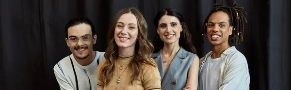 stock image headshot of happy multicultural team smiling at camera near black drape in office, horizontal banner