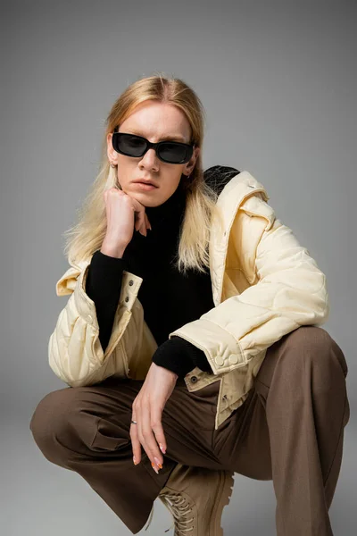 Appealing Androgynous Person Stylish Outfit Sunglasses Squatting Fist Chin — Stock Photo, Image