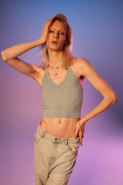 vertical shot of red haired androgynous model in black stylish turtleneck looking at camera