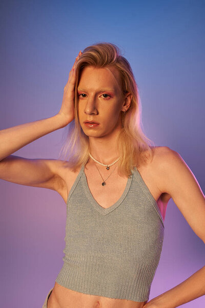 vertical shot of red haired androgynous model in black stylish turtleneck looking at camera