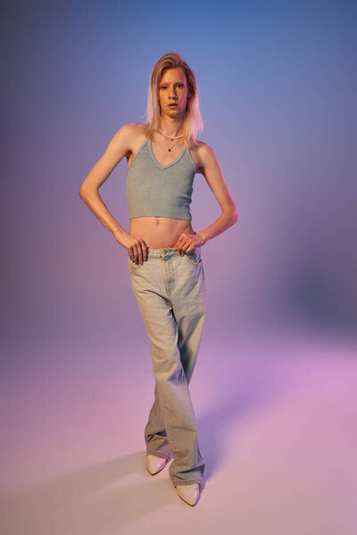vertical shot of red haired androgynous model in black stylish turtleneck looking at camera
