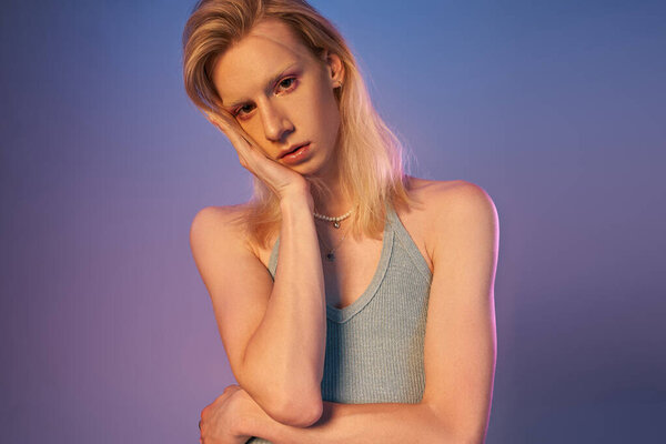 vertical shot of red haired androgynous model in black stylish turtleneck looking at camera