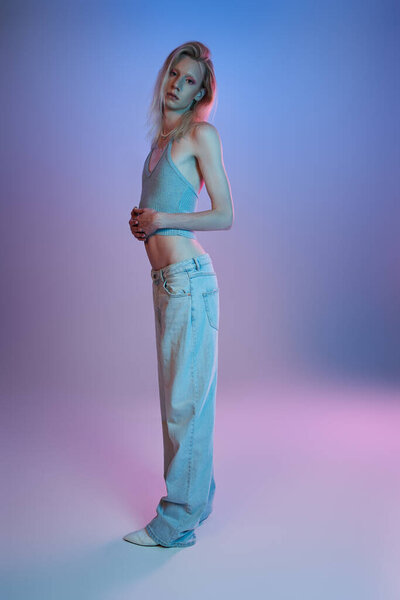 vertical shot of red haired androgynous model in black stylish turtleneck looking at camera