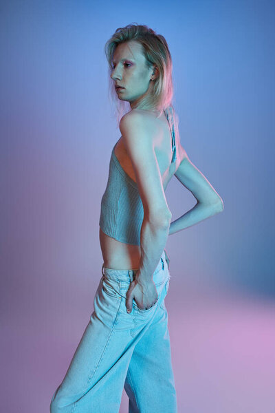 vertical shot of red haired androgynous model in black stylish turtleneck looking at camera