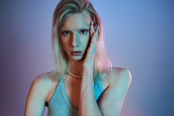 vertical shot of red haired androgynous model in black stylish turtleneck looking at camera