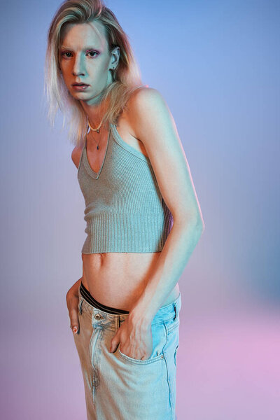 vertical shot of red haired androgynous model in black stylish turtleneck looking at camera