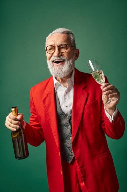 cheerful man dressed as Santa with beard enjoying champagne and smiling sincerely, winter concept clipart
