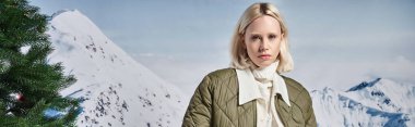 beautiful stylish woman in modish warm jacket with mountain backdrop, winter fashion, banner clipart