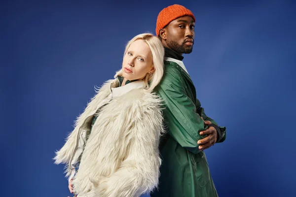 stock image multiethnic couple posing in winter attire with mountain on backdrop, african american man and woman