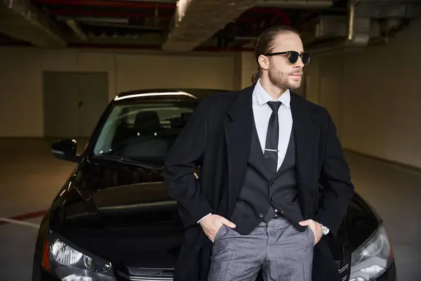 stock image attractive bearded man with sunglasses posing near his car with hands in pockets, business concept