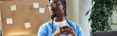 thoughtful african american doctor with stethoscope sitting at office and looking away, banner clipart