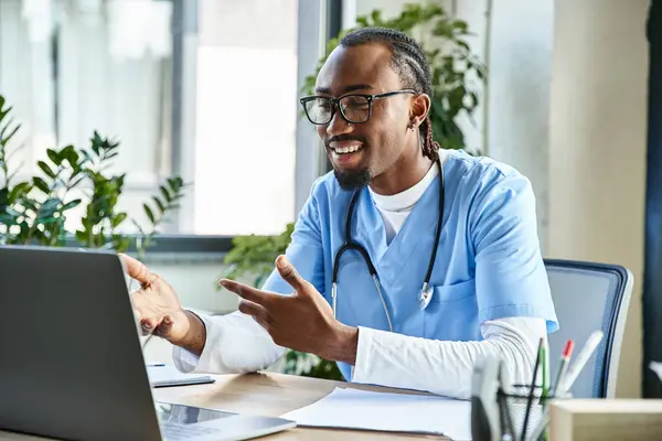 stock image young happy african american doctor with glasses consulting someone by phone and gesturing actively