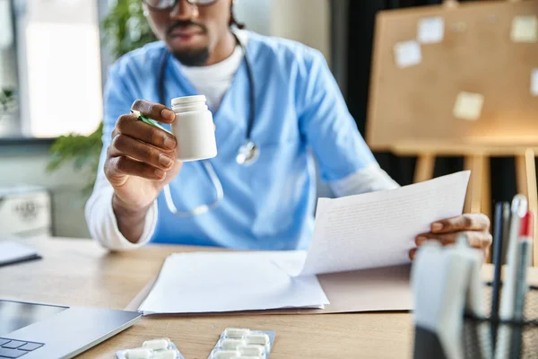 stock image cropped view of african american doctor with stethoscope holding pills and notes, telemedicine