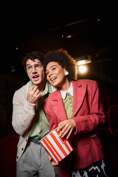 happy multicultural couple in casual stylish attires enjoying their date at cinema, Valentines day