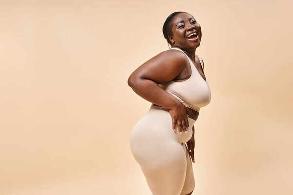 cheerful african american plus size woman embracing self-love and confidence, body positive