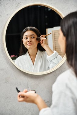 young asian woman with brunette hair and acne applying powder with brush, skin issues and makeup clipart