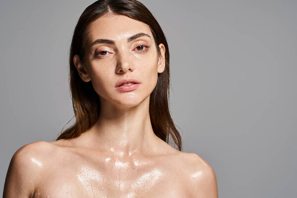 A young Caucasian woman with brunette hair has a lot of water on her body, creating a mesmerizing and dreamy effect.