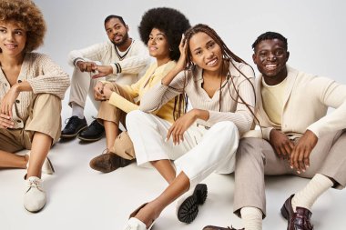 group of cheerful african american people in casual attire sitting on grey background, Juneteenth clipart