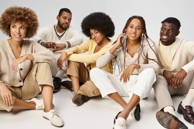 group of optimistic african american people in casual attire sitting on grey background, Juneteenth clipart