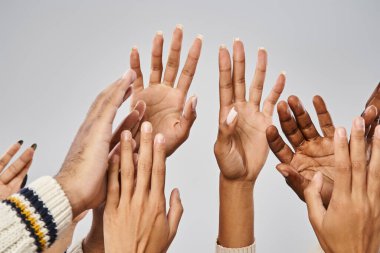 cropped view of african american people outstretching hands on grey background, Juneteenth concept clipart