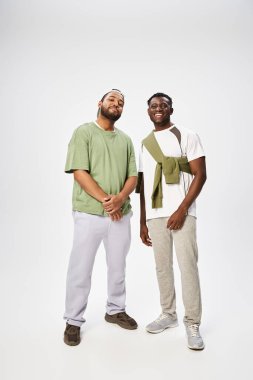 joyful african american men in casual wear standing together on grey background, Juneteenth clipart