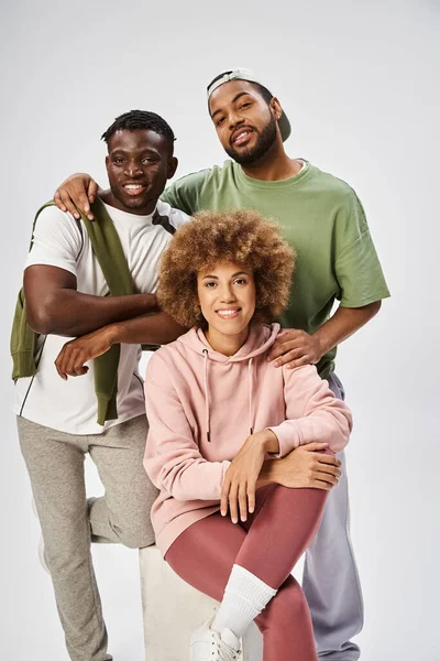 stock image cheerful african american friends looking at camera on grey background, Juneteenth celebration