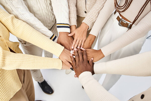 top view of african american people stacking hands together on grey background, Juneteenth