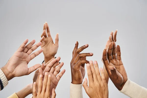 cropped view of african american community outstretching hands on grey background, Juneteenth