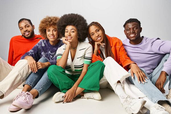 african american community in vibrant attire spending time together on grey backdrop, Juneteenth
