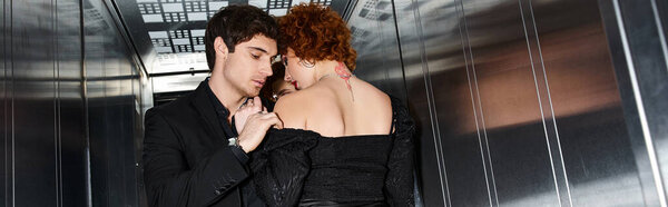 sexy couple in stylish evening black dress and suit hugging in elevator after date, banner