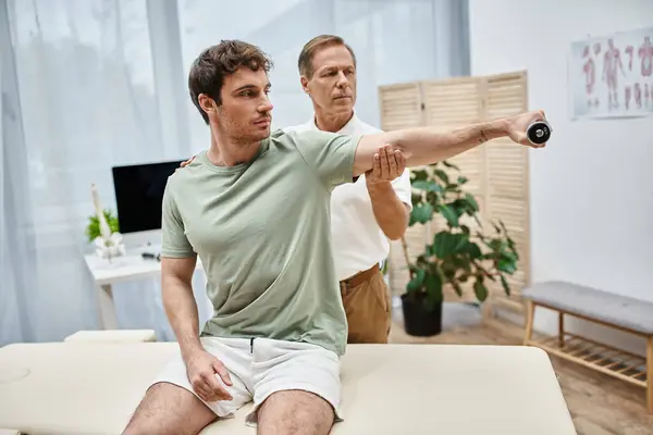 Mature Handsome Doctor Helping His Attractive Patient Use Dumbbell Rehabilitation — Stock Photo, Image