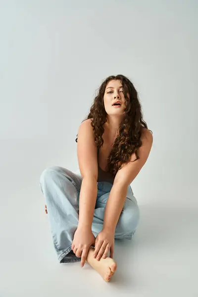 Seductive Curvy Woman Brown Bra Blue Jeans Sitting Leaning Forward — Stock Photo, Image