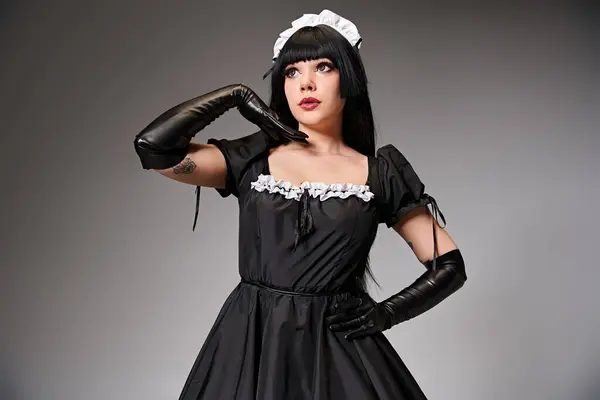 Attractive Young Cosplayer Maid Costume Posing Alluringly Looking Away Gray — Stockfoto