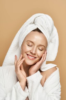 An attractive woman with natural beauty, actively posing with a towel draped elegantly over her head. clipart