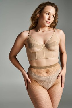 Bronzlaşmış sütyen ve file külotla poz veren doğal bir güzellik zarafet ve cazibeyle.