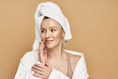 A woman with a towel on her head, revealing her natural beauty while exuding serenity and renewal. clipart