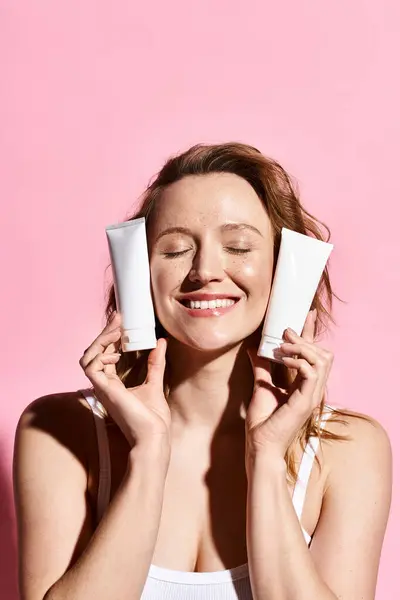 Attractive Woman Playfully Holding Cream Front Her Face Showcasing Natural — Stock Photo, Image