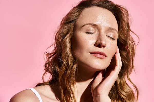 A woman with closed eyes rests her hand under her chin, portraying a tranquil and contemplative moment.