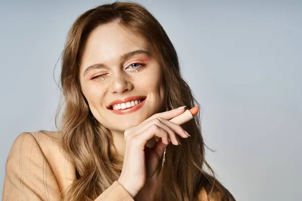 Winking Woman Face Jewels Beige Jacket Holding Lipstick Peach Color — Stock Photo, Image